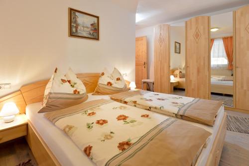 a bedroom with a bed with two pillows on it at Appartement Claudia in Going am Wilden Kaiser