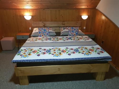 a bedroom with a bed with a wooden headboard at Vila Kamila in Tatranska Strba