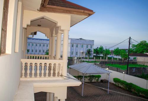 a balcony of a building with an umbrella at SULKHAN SERVICED APARTMENT in Chukwani