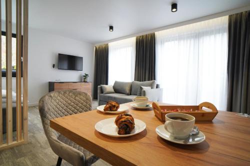 a living room with a table with food on it at Beskidzka9 & Free Sauna in Szczyrk