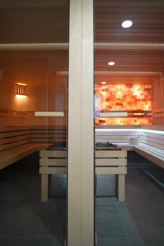 a kitchen with two tables and a counter with food at Beskidzka9 & Free Sauna in Szczyrk