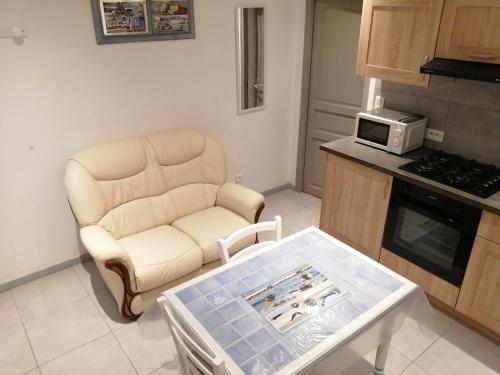a living room with a couch and a coffee table at gite repos et tranquillité P in Cayeux-sur-Mer