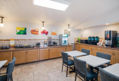 a restaurant with tables and chairs and a counter at Quality Inn & Suites Coeur d'Alene in Coeur d'Alene