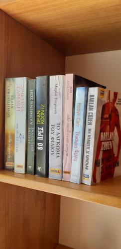 a row of books sitting on a shelf at Παλατάκι in Patra