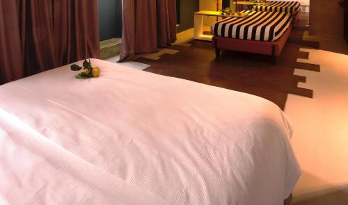 a bedroom with a white bed with fruit on it at Hotel Locanda del Benaco in Salò