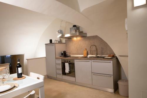 a kitchen with a sink and a stove top oven at Casa Ferretti in Iesi