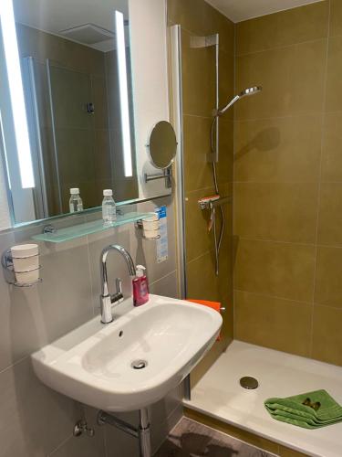 a bathroom with a sink and a shower at Astrid's Pension in Winterberg