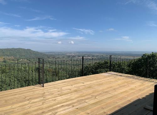 a wooden deck with a view of the ocean at Vuelos de Montaña l in Montánchez