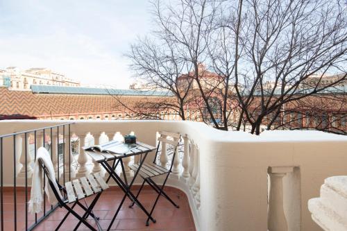 a balcony with a table and chairs on a balcony at Aspasios Market Balconies Apartments in Barcelona