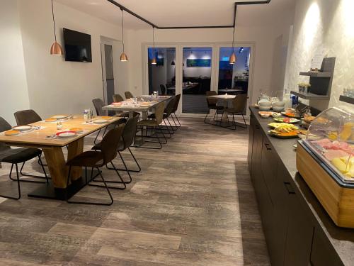 a kitchen and dining room with tables and chairs at Astrid's Pension in Winterberg
