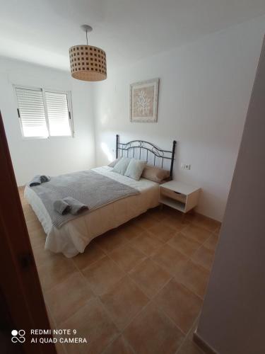 a bedroom with a bed and a tiled floor at Mar azul in Almazora