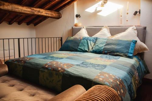 a bedroom with a bed with a quilt on it at La Torre in Torrita di Siena