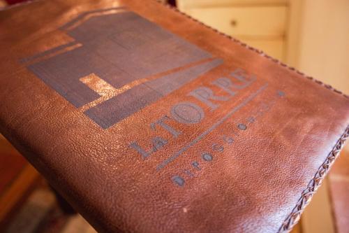 a close up of the back of a brown leather chair at La Torre in Torrita di Siena
