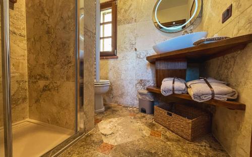 a bathroom with a shower and a sink and a toilet at La Torre in Torrita di Siena
