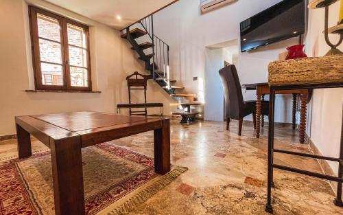 a living room with a table and a television at La Torre in Torrita di Siena