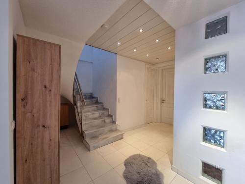 a hallway with a staircase in a house at Alpenapart Schultes Sports in Jerzens