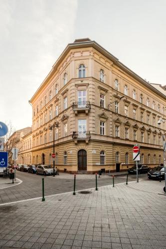 a large building on a street with cars parked in front at Grand Budapest Penthouse in Budapest