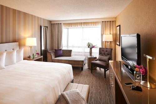 a hotel room with two beds and a television at The Prince George Hotel in Halifax