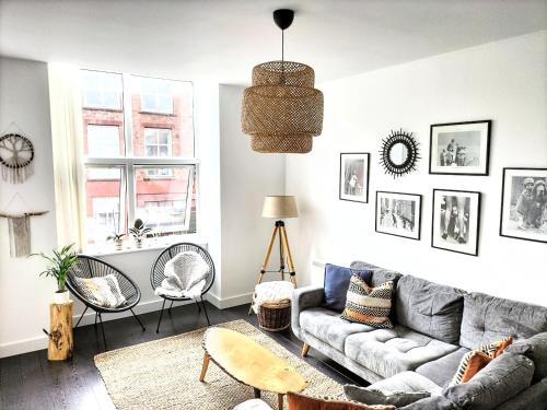 a living room with a gray couch and chairs at Stylish & Cosy Abode with FREE parking. in Liverpool