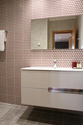 a bathroom with a sink and a mirror at Pine Tree Apartments - Praia da Coelha - Albufeira in Albufeira