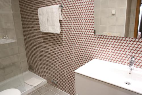 a bathroom with a sink and a toilet and a shower at Pine Tree Apartments - Praia da Coelha - Albufeira in Albufeira