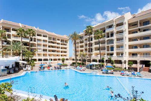 a large swimming pool in front of a resort at Listen THE STARS 505 - Los cristianos in Los Cristianos