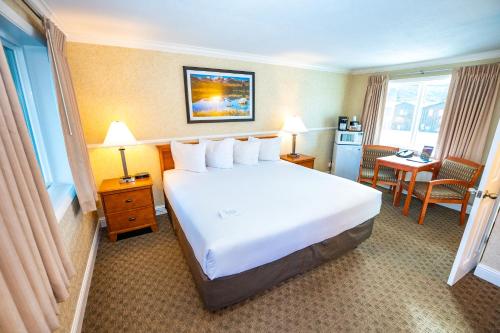 a hotel room with a large bed and a desk at Blue Door Inn in Estes Park