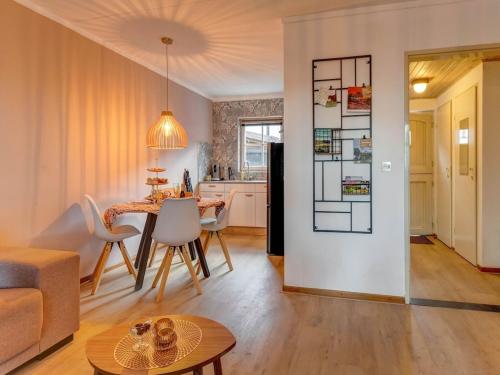 a living room and kitchen with a table and chairs at Beautiful holiday home in Voerendaal in Voerendaal