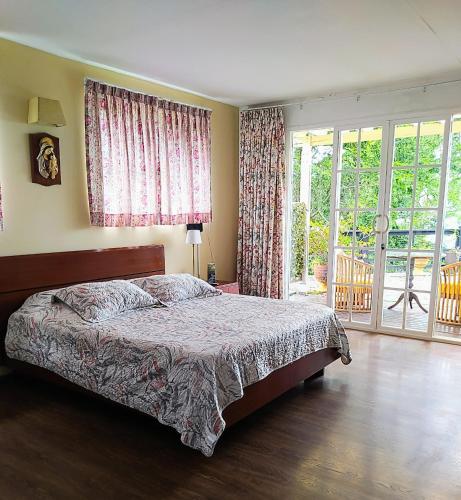 a bedroom with a bed and a large window at Condominio Hacienda Shangrila in San Francisco