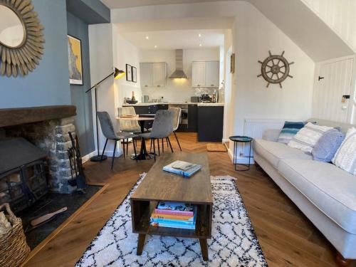 a living room with a couch and a table at Cosy 2 bedroom cottage in Scarborough's Old Town in Scarborough