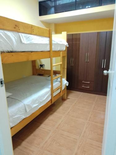 a room with two bunk beds and a hallway at Hostería "Don Pelu" - Máncora, Piura in Máncora