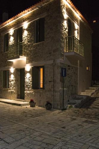a large stone building with two balconies at night at Stone Villa in Pythagoreio