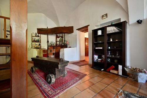a living room with a room with a table and a fireplace at Bastide Beaudinard in Aubagne