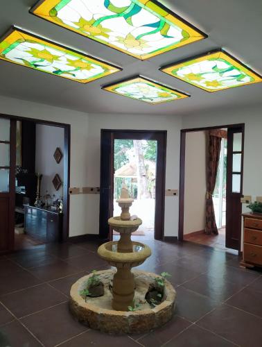 a fountain in the middle of a room with stained glass ceilings at Condominio Hacienda Shangrila in San Francisco