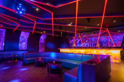 a nightclub with purple and blue lights and a bench at Moon Palace The Grand Cancun All Inclusive in Cancún