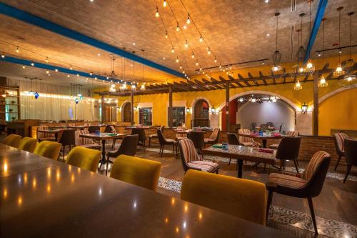 a restaurant with tables and chairs in a room at Moon Palace The Grand Cancun All Inclusive in Cancún