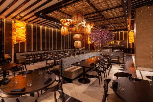a restaurant with tables and chairs and lights at Moon Palace The Grand Cancun All Inclusive in Cancún
