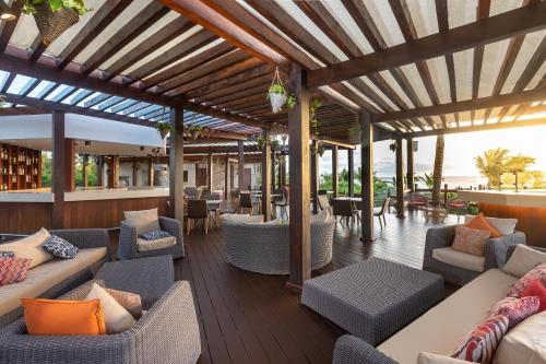 an outdoor patio with couches and chairs and tables at Moon Palace The Grand Cancun All Inclusive in Cancún