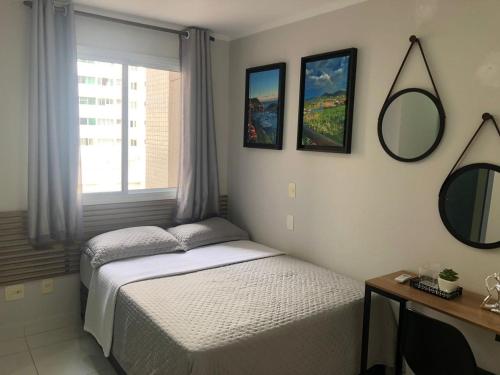 a bedroom with two beds and a mirror on the wall at ACONCHEGO E BEM ESTAR in Brasilia