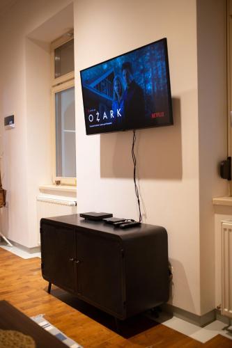 a flat screen tv hanging on a wall at Alessia Apartment in the Old Town in Timişoara