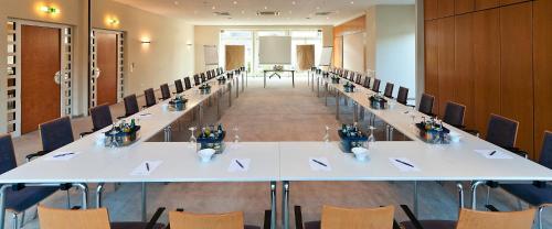 a large conference room with a long table and chairs at Hotel Ambiente Walldorf in Walldorf