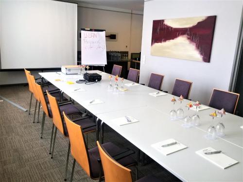 a large conference room with a long table and chairs at Hotel Ambiente Walldorf in Walldorf