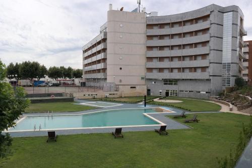an empty swimming pool in front of a building at Grande Hotel Dom Dinis in Mirandela