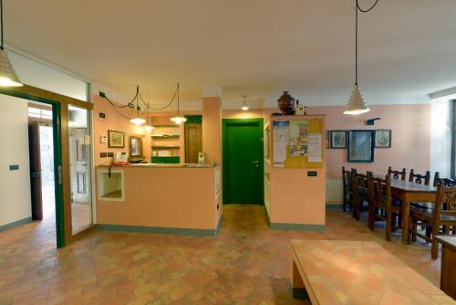a large room with a kitchen and a dining room at Albergo Al Tempo Perduto in Bagolino