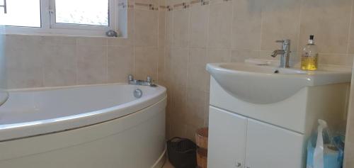 uma casa de banho com um lavatório, uma banheira e um WC. em 2 Bed semi-detached house em Poole