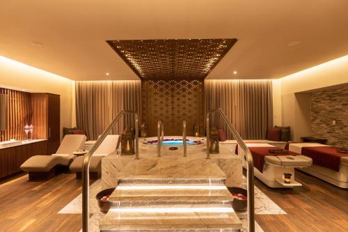 a hotel room with a staircase leading to a pool at Moon Palace Cancun - All Inclusive in Canc&uacute;n