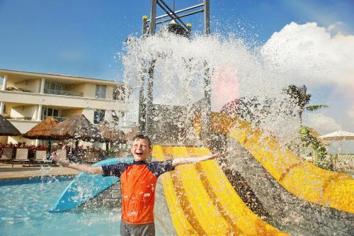 a young boy standing in front of a fountain at Moon Palace Cancun - All Inclusive in Cancún