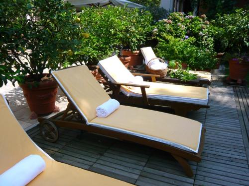 a couple of lounge chairs sitting on a patio at Villa Abbazia Relais & Chateaux in Follina