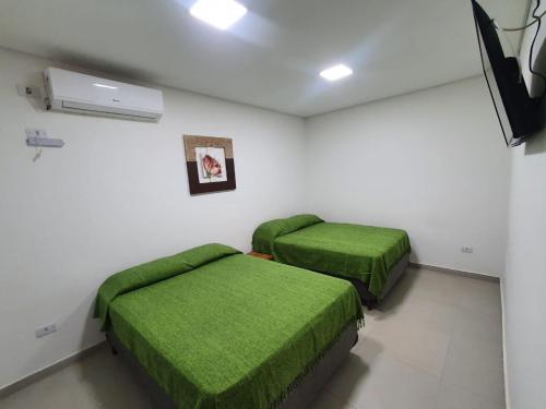 Ένα ή περισσότερα κρεβάτια σε δωμάτιο στο Flats Olímpia Thermas
