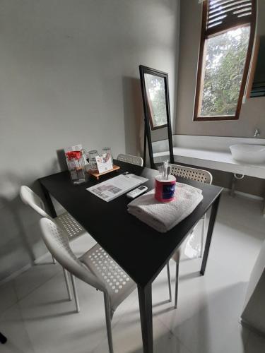 a black table with chairs and a sink in a bathroom at SaBi Guest House - Strategic Family -married couples only- Hostel in Prawirotaman in Yogyakarta